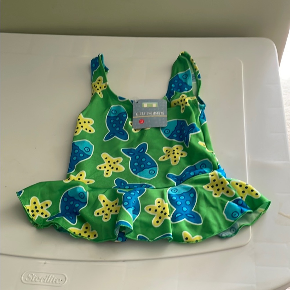 Girl’s Green Starfish and Fish Print Swimsuit in size medium.